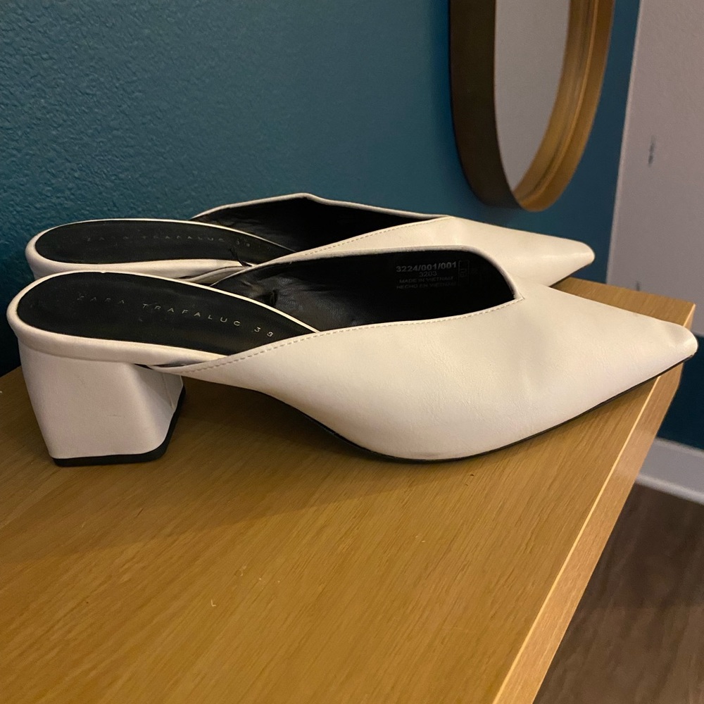 White leather slip on mules.